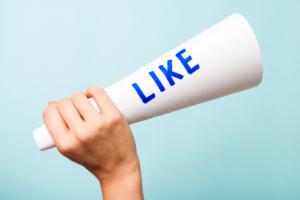 Hand holding a &quot;like&quot; megaphone