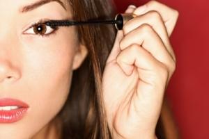 A woman applying makeup.