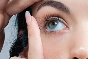 A woman applying contact lenses.