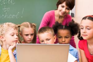 Children at school looking at a computer.