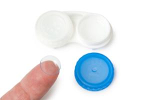 A finger pointing to a contact lenses case.