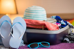 A suitcase filled with clothes and accessories for traveling.