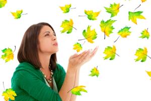 A woman blowing leaves.