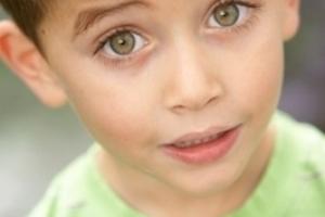 A young boy with a green shirt.