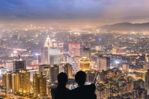 two people looking out to a city view