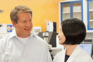 John Weber smiling at an employee