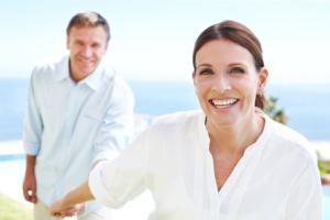 A mature couple smiling outdoors.