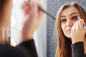 A woman applying makeup.