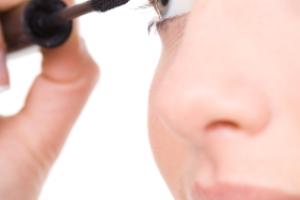 A woman applying makeup.