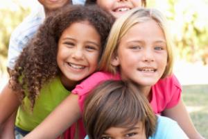 Children smiling outdoors.