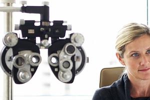 A woman at an eye exam appointment with an optometrist.