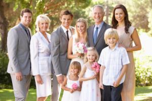 A family smiling at a wedding.