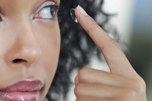 A woman applying contact lenses.