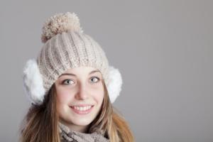 A woman smiling with a winter beanie.