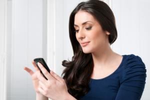 A woman looking at a smartphone.