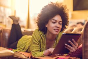 woman on a sofa with a tablet.