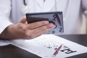 optometrist holding tablet