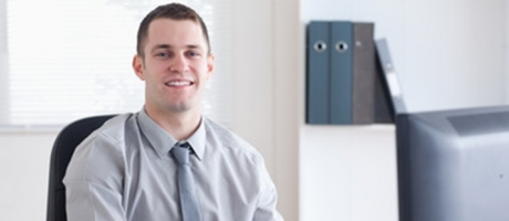 man smiling while using the computer