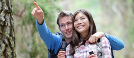 man and woman smiling on a hike